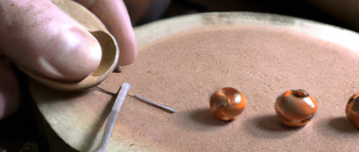 What is the process involved in creating hand-carved wood jewelry?